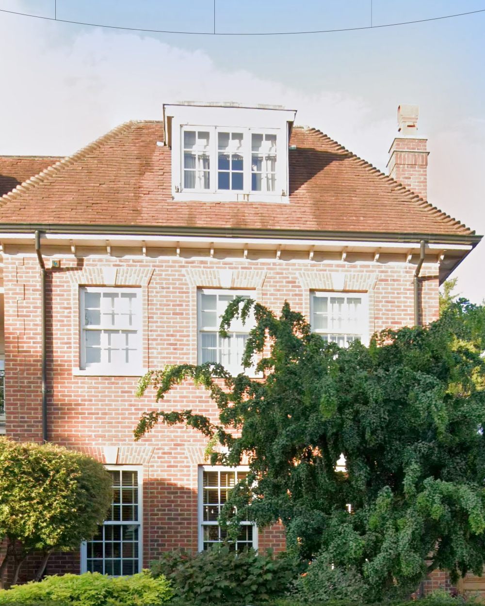 Detail of the dormer window, chimney, bracketed cornice and sash windows